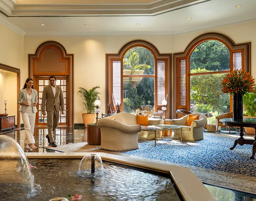 Couple walking in luxurious lobby of The Oberoi Bengaluru.